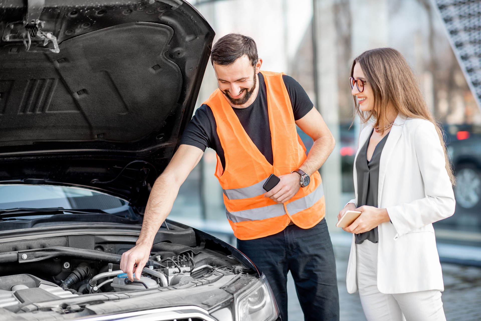 Service worker with businesswoman and car